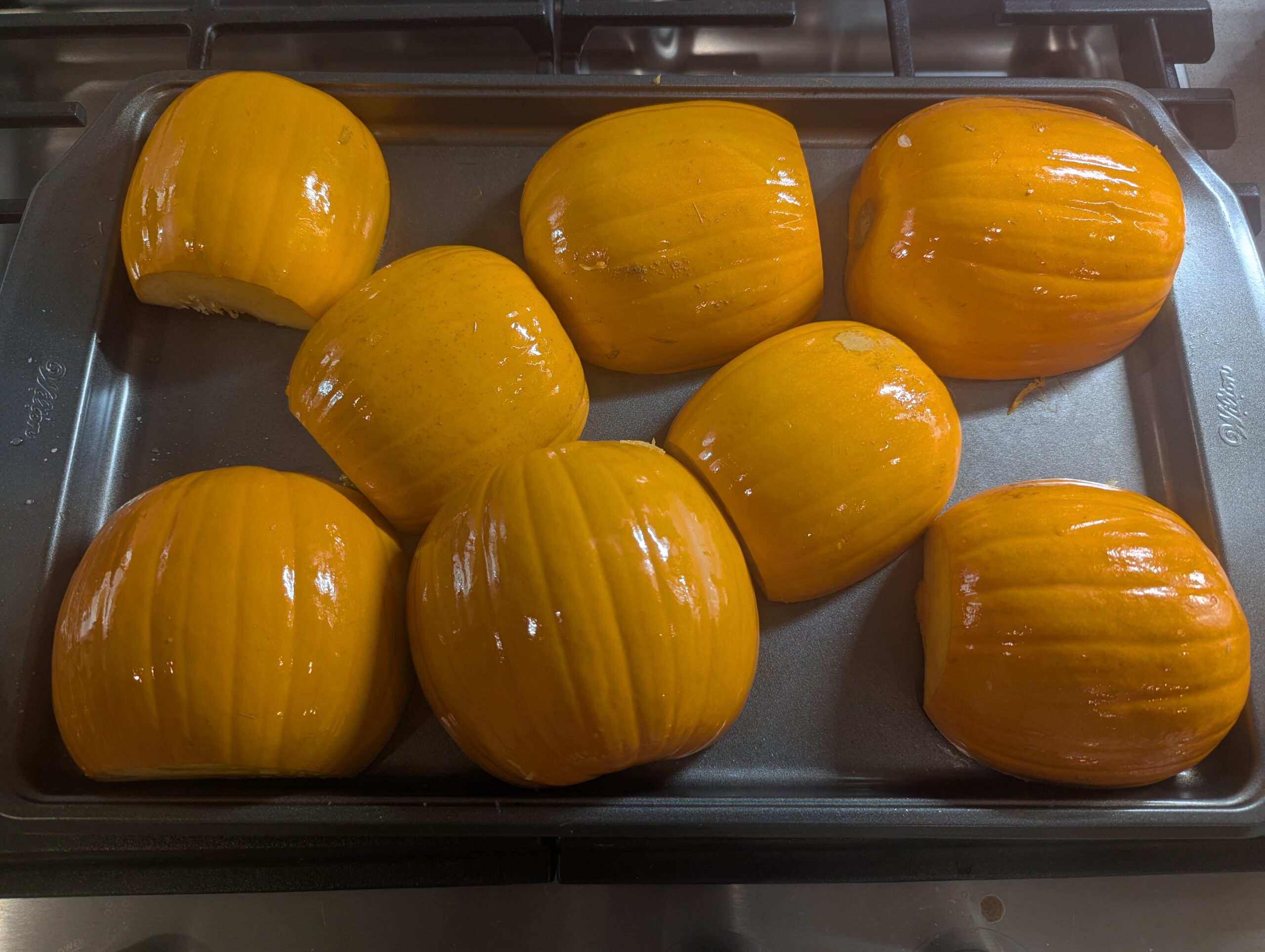 4 little pie pumpkins halved, greased up, and ready for the oven.