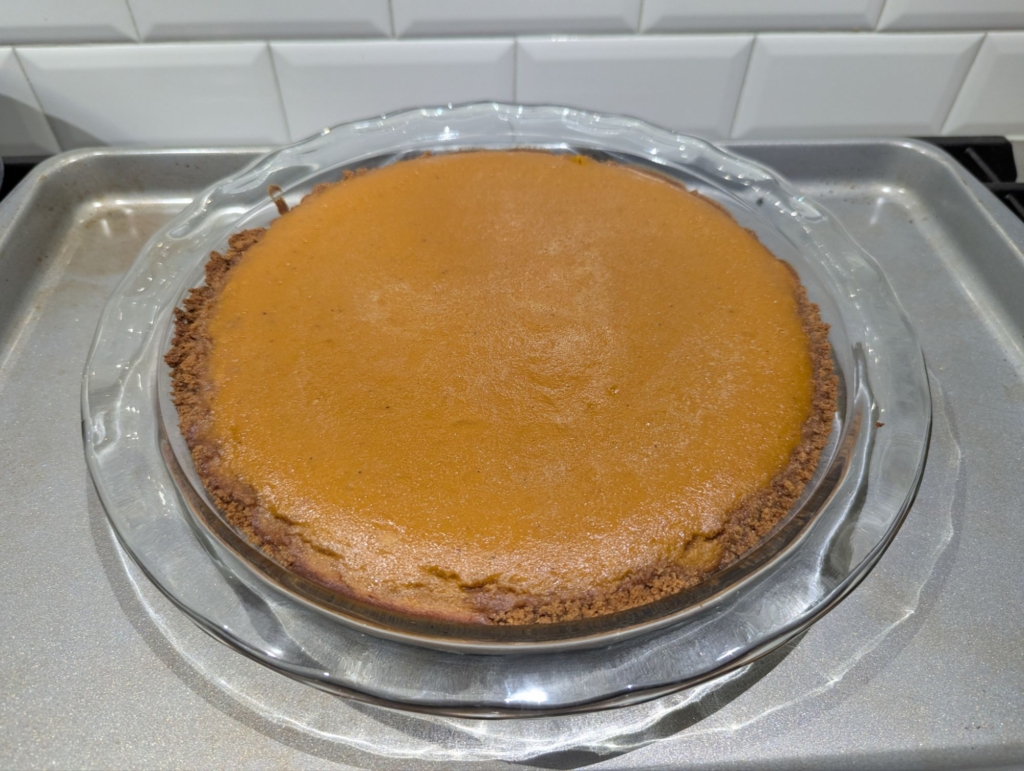 A photo of a pumpkin pie straight out of the oven