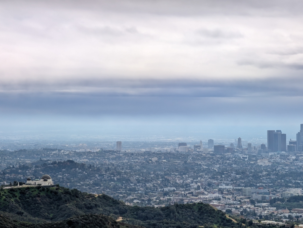 An photo of the Griffith Observatory from above. Downtown LA is off in the distance.