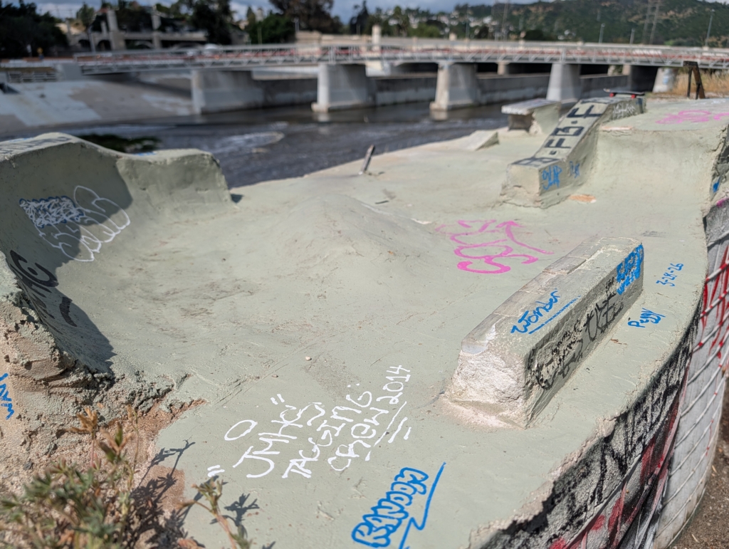 A photo of a mini skate park, built for finger boards, installed next to the LA River.