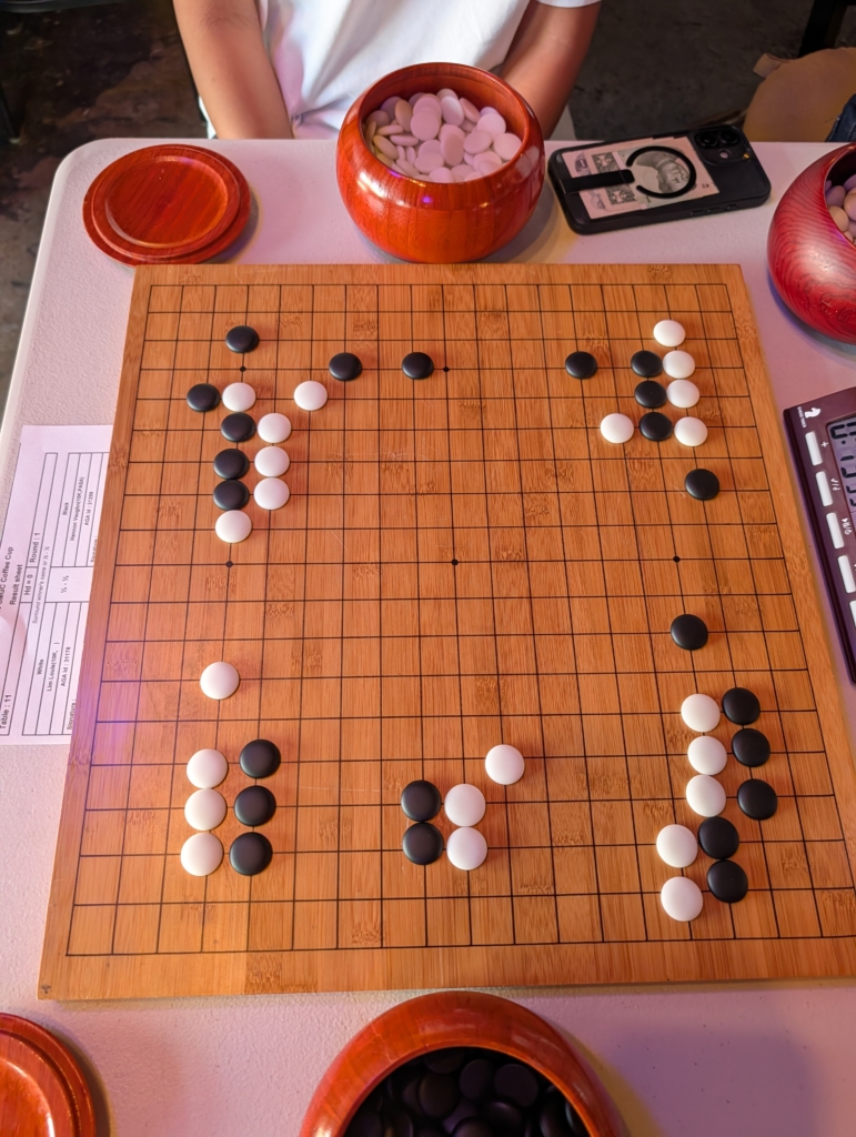 Photo of a Go board as the game enters the mid game. 